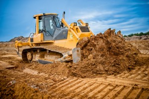 Excavator working with earth and sand in sandpit